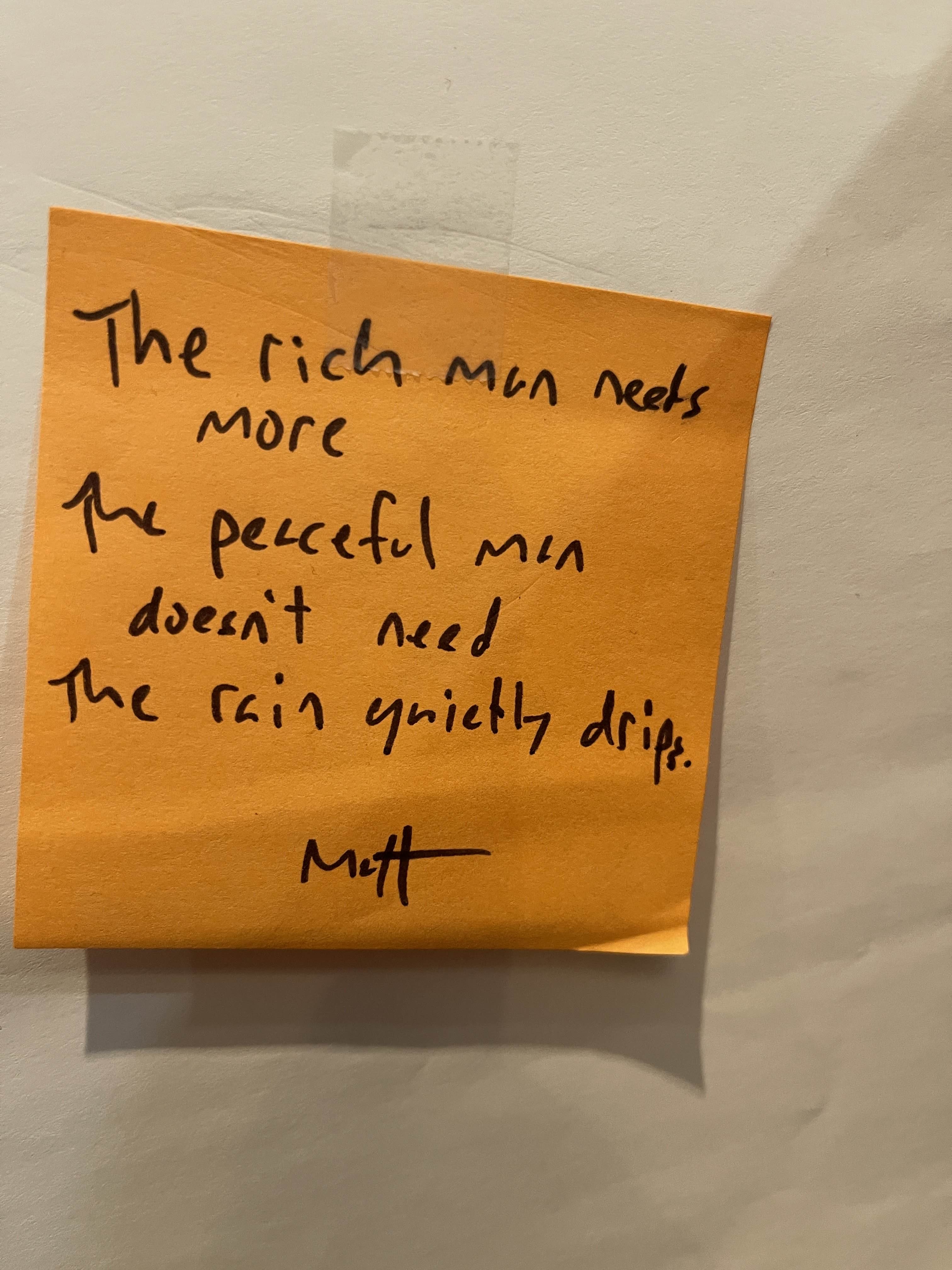 A handwritten haiku on a sticky note