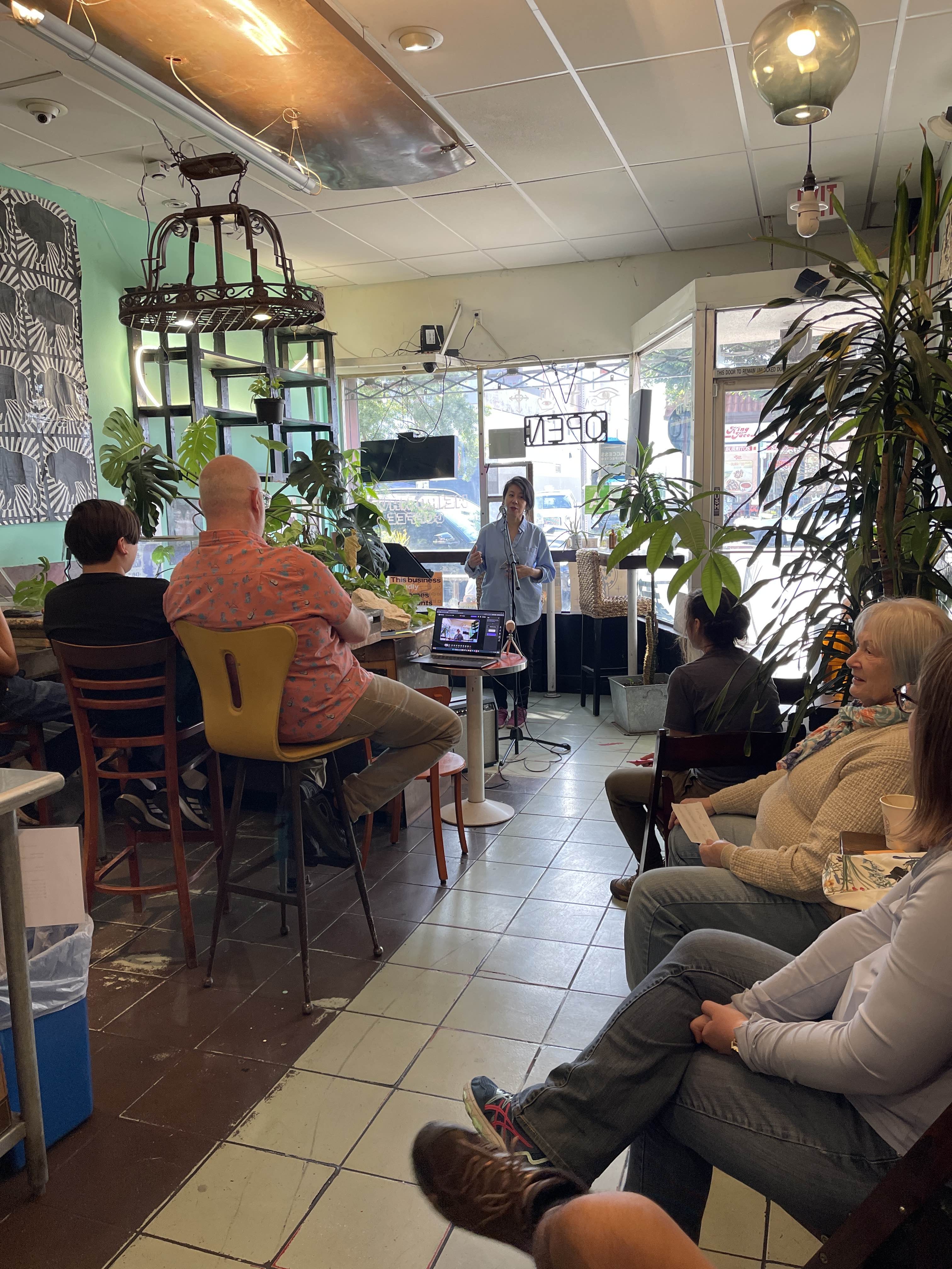 People seated in a circle listening attentively during a Democracy Haiku gathering